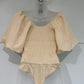 SHORT PUFF SLEEVE BODYSUIT WITH SMOCKING DETAIL - NATURAL